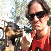 Photo of Colin Fay with a goat